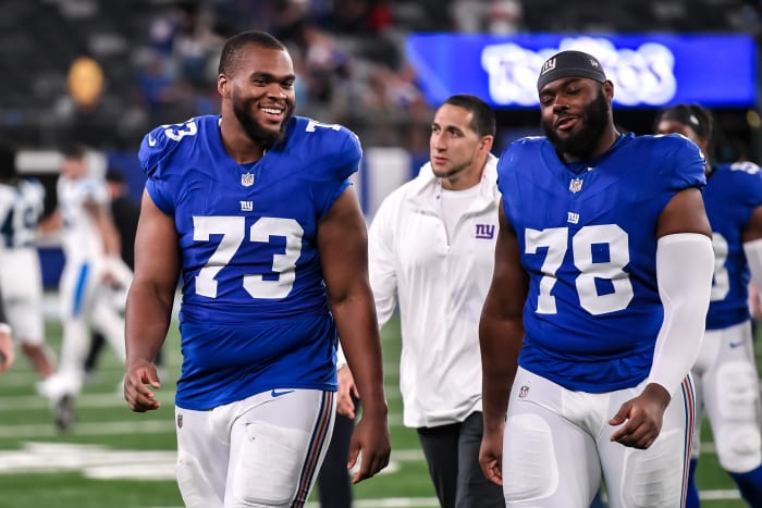 Aug 18, 2023; East Rutherford, New Jersey, USA; New York Giants offensive tackle Evan Neal (73) and New York Giants offensive tackle Andrew Thomas (78) exit the field after defeating the Carolina Panthers at MetLife Stadium.